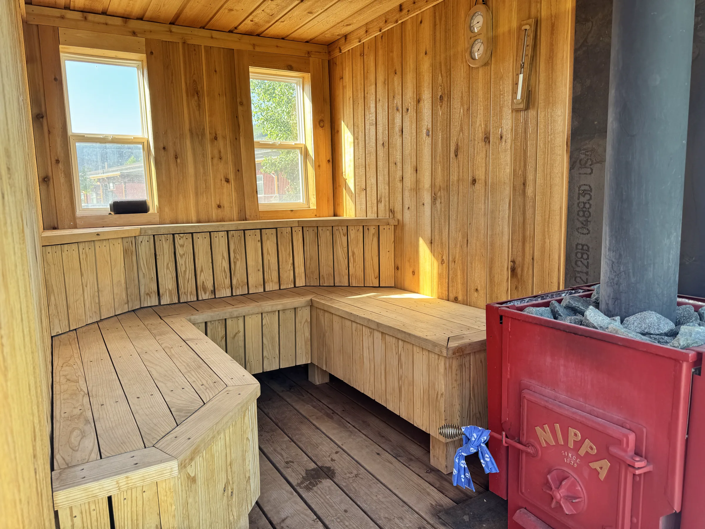 Cedar interior and red NIPPA wood stove inside the Mito Heat sauna
